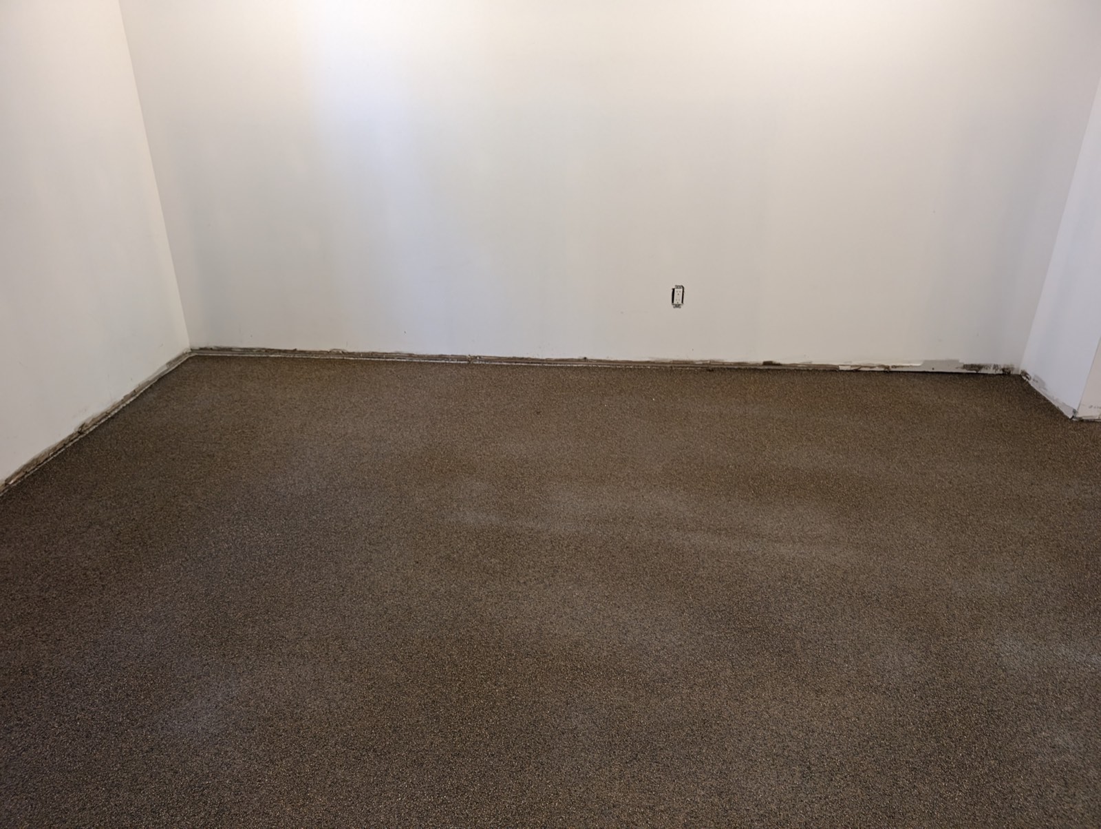 Pièce de sous-sol avec plancher d'époxy à flocons bruns
