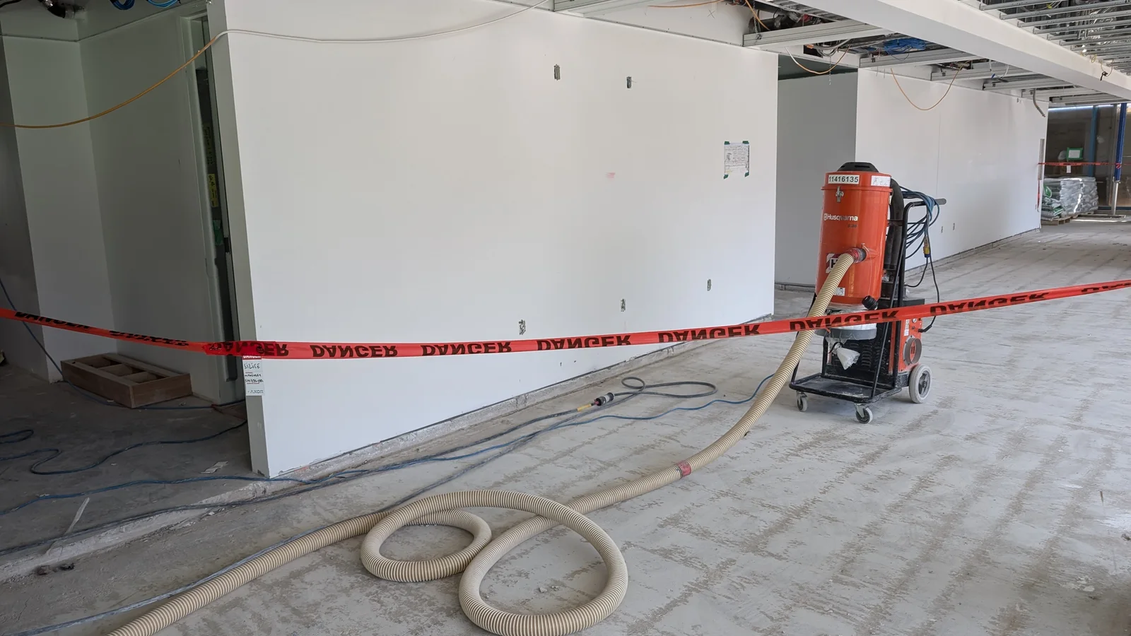 Équipement d’aspiration relié à une préparation mécanique de dalle dans un local commercial